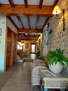 a living room with a couch and a stone wall at Posada Campa in Sierra de Ibio
