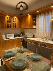 a kitchen with a table with plates and wine glasses at Deppy's House in Naousa +6 photos