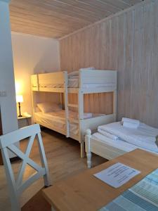 a room with two bunk beds and a table at Furudals Bruk in Furudals Bruk