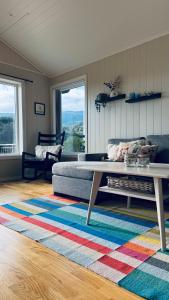a living room with a couch and a coffee table at Cabin by the lake with 3 bedrooms in Kvam