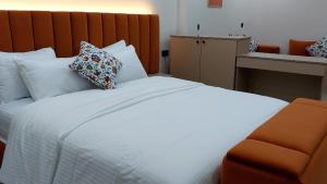 a bedroom with a large white bed with pillows at Studio Marzouga in Deroua