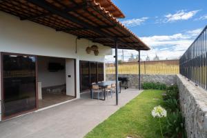 an outdoor patio with a table and a television at Casa Xanu in Tapalpa