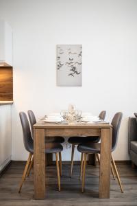 a dining room table with chairs and a painting at Stylish Natural Studio Central Budapest in Budapest