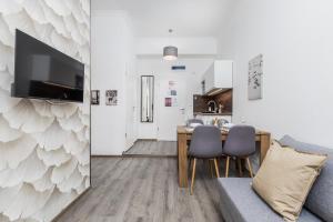 a living room with a table and chairs and a kitchen at Stylish Natural Studio Central Budapest in Budapest +31 photos