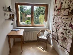 a room with a table and a chair and a window at Einliegerwohnung in ruhiger Lage in Gunningen
