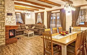 a living room with a table and a fireplace at Amazing Home In Gospic With Wi-Fi in Gospić +12 photos
