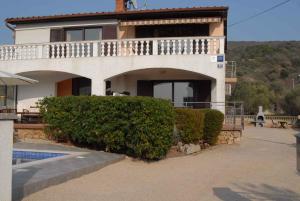a house with a swimming pool in front of it at Apartment in Punat - Insel Krk 13350 in Punat