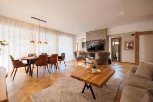 a living room with a table and a dining room at Aqua Thermal Villa Banya in Banya