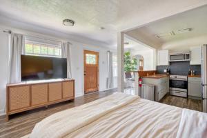a large bedroom with a large flat screen tv at Forest Studio Retreat - Near Multnomah Village in Portland +29 photos