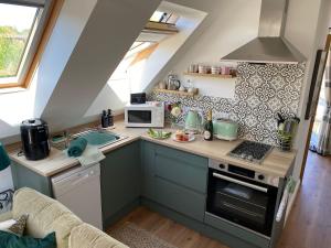 a small kitchen with a sink and a stove at Grove View Studio Apartment in Cossington