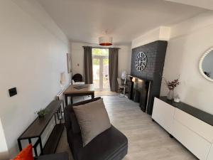 a living room with a couch and a fireplace at Abbey Wood Residence in Abbey Wood