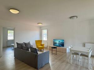 a living room with a couch and a table at 1Dest - The Roman Spot in Riva del Garda