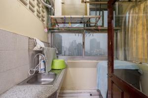 a kitchen with a sink and a tub and a window at White Base in Bangkok +35 photos