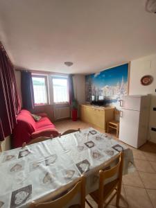 a living room with a table and a kitchen at Casa Mara - Agriturismo Fantelli Luciano in Dimaro +15 photos