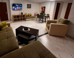 a living room with two couches and a table at Family apartment NZ in Tangier