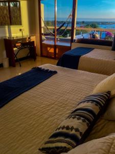 Postel nebo postele na pokoji v ubytování Galápagos Casa Playa Mann
