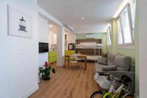 a living room with a couch and a dining room at Araba-Berri in Zarautz +6 photos