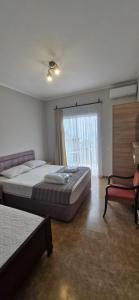 a bedroom with a large bed and a window at PharphalInn in Batumi