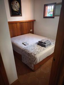 a small bedroom with a bed with white sheets at Valle Niza, N 340, 21, Villa Playa in Vélez-Málaga