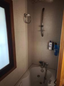 a bath tub in a bathroom with a shower at Valle Niza, N 340, 21, Villa Playa in Vélez-Málaga +48 photos