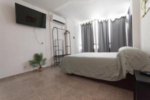 Voodi või voodid majutusasutuse Piso con Piscina comunitaria toas +32 fotot