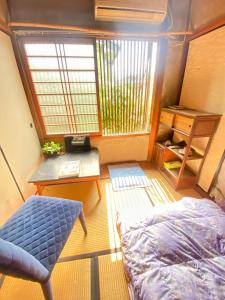 a small room with a bed and a desk at International Guest House Tani House in Kyoto +288 photos