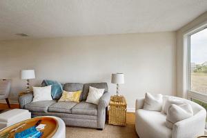 a living room with a couch and a chair at Bay Pointe 2119 in Seabrook Island
