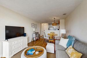a living room with a couch and a flat screen tv at Bay Pointe 2119 in Seabrook Island