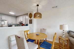 a living room with a table and chairs and a kitchen at Bay Pointe 2119 in Seabrook Island +14 photos
