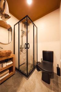 a bathroom with a shower and a black toilet at Tare Suites Beşiktaş in Istanbul +46 photos