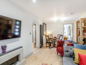 a living room with a couch and a fireplace at Orchard Retreat in Kirton
