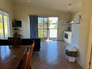 a living room with a dining table and a kitchen at Kingston Foreshore Caravan Park in Kingston South East