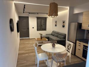 a living room with a table and a couch at Sofia's Home in Chania Town