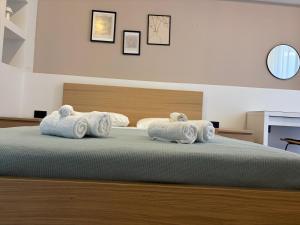 a bedroom with a bed with towels on it at Sofia's Home in Chania Town