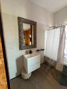 a bathroom with a sink and a mirror at El Santuario Paracas in Paracas