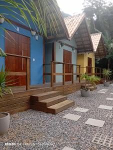 a house with wooden stairs in front of it at Recanto do Sossego in São Sebastião