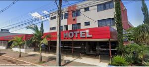 a hotel building with a red and white facade at Hotel Ideal Beltrão in Francisco Beltrão