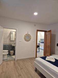 a bedroom with a bed and a bathroom with a toilet at Apartments with parking space Pakostane, Biograd - 22375 in Pakoštane