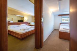 a bedroom with two beds and a mirror at Rio apartments in Banja Luka