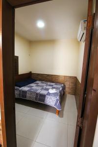 Cama o camas de una habitación en Casa com ar-condicionados e localização perfeita