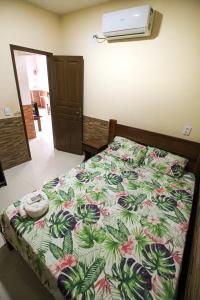 Cama o camas de una habitación en Casa com ar-condicionados e localização perfeita