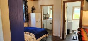 a small kitchen with a refrigerator in a room at The Seneca Sunset Suites in Burdett