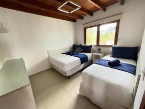 a bedroom with two beds and a window at Reserva BG - Apto Peixe Boi - Frente mar in Barra Grande