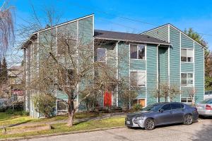 a blue house with a car parked in front of it at Private Room "Cherry" by UW in Seattle