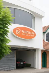 a sign for a restaurant with a car in a garage at Hotel Fundidora in Monterrey
