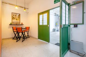 a room with a green door and a table and chairs at Hotel Fundidora in Monterrey +68 photos