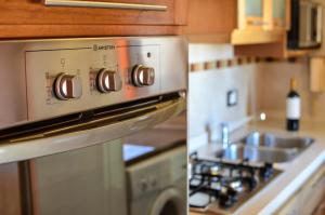 a kitchen with a stove top oven next to a sink at Balcones al Nahuel in San Carlos de Bariloche +7 photos
