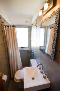 a bathroom with a sink and a toilet and a window at Balcones al Nahuel in San Carlos de Bariloche