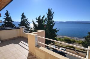 a balcony of a house with a view of the water at Balcones al Nahuel in San Carlos de Bariloche
