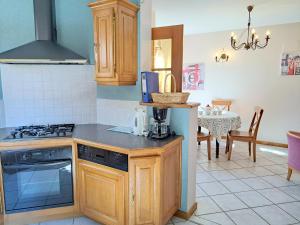 a kitchen with a stove top oven next to a table at House near Vosges Park and La Petite Pierre in Hinsbourg +24 photos